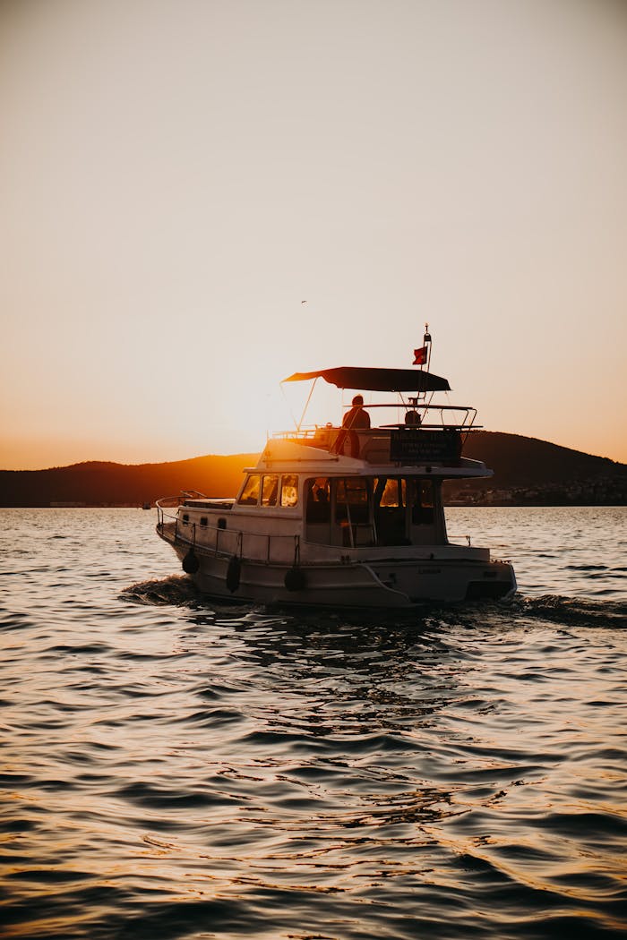contact-header Elegant yacht sailing at sunset on the Aegean Sea near Ayvalık, Türkiye.